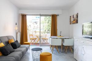 a living room with a couch and a table at Martelly furnished flat in Antibes