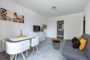 a living room with a couch and a table at Martelly furnished flat in Antibes