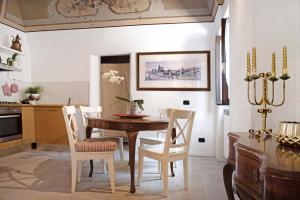 a kitchen and dining room with a wooden table and chairs at Dimora Vittoria - Lago Maggiore in Casalzuigno