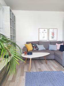 a living room with a couch and a table at APARTAMENT NIEBO in Kołobrzeg