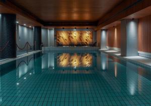 a large swimming pool with chairs and tables at Original Sokos Hotel Presidentti Helsinki in Helsinki