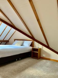 a bedroom with a bed in a attic at The Beacons Guest House in Brecon