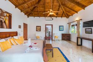 um quarto com uma cama e uma ventoinha de tecto em A Golf Lover's Dream Villa with 4 Bedrooms, Pool, Jacuzzi, and Maid em Punta Cana