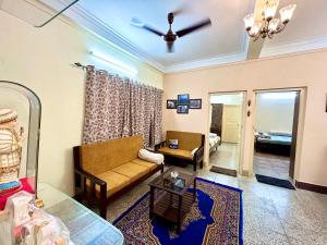 a living room with a couch and a table at Classic 2BHK Serviced Apartment beside Jadavpur University in Kolkata