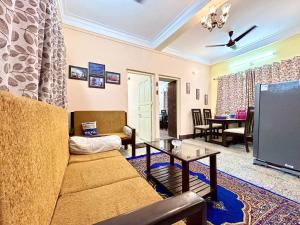 a living room with a couch and a tv at Classic 2BHK Serviced Apartment beside Jadavpur University in Kolkata