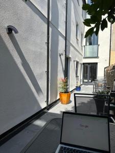 a laptop computer sitting on a table on a balcony at Central Studios in Cardiff