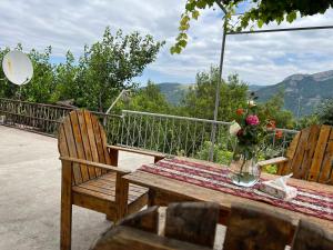 a wooden table with a vase of flowers on it at Arman Bed and Breakfast in Halidzor