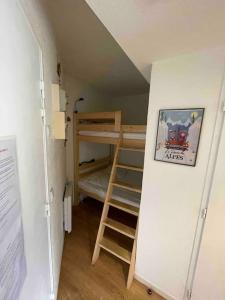 a small room with bunk beds and a ladder at App 4/6 pers plein centre des 2alpes 100 m pistes in Les Deux Alpes