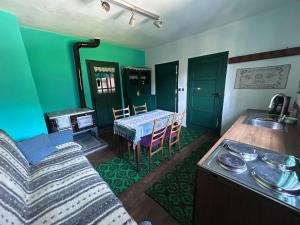 a living room with a couch and a table at Casa Verde in Lupşa