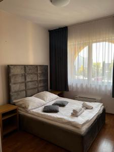 a bedroom with a large bed with two towels on it at Hotel U Grubego in Wielogóra