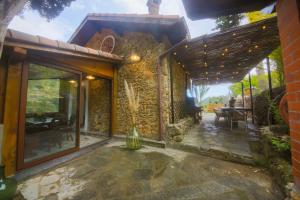 an external view of a stone house with a patio at DOLCE VITA CIAIXE in Camporosso