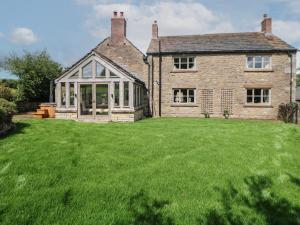 an external view of a house with a large yard at Stag Cottage in Macclesfield