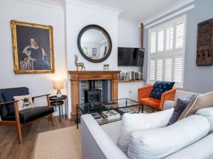 a living room with a couch and a fireplace at Pass the Keys Stylish Waterside Home in Central Worcester in Worcester