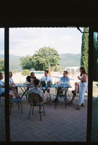 een groep mensen die aan een tafel zitten bij VIN Hotel - Wine Resort and Agriturismo Montieri in Montieri