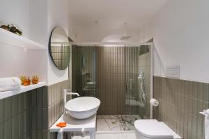 a bathroom with a toilet and a glass shower at Gio Mar Blu in Piano di Sorrento +30 photos