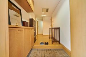 a hallway with two pairs of shoes on the floor at Guest House Kingyo - Vacation STAY 14497 in Sapporo
