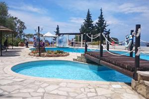 a pool at a resort with a wooden bridge at Cyprus style Stone Villa in Paphos City