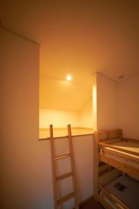 a room with a bunk bed with a ladder in it at Guest House Kingyo - Vacation STAY 14498 in Sapporo