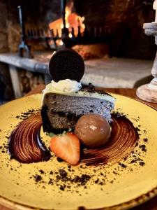 a chocolate dessert on a yellow plate on a table at Sign of the Angel in Lacock