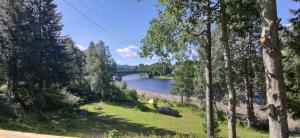 a view of a river with a bridge in the background at Relaxing home in Svarstad