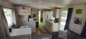 a kitchen and living room with a caravan at Relaxing home in Svarstad