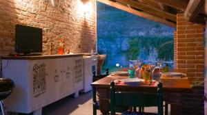 a dining room with a table and a television at Cascina Solaro in Asti