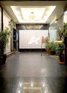 a lobby with a large screen in the middle of a building at HOTEL BLUE PEARL in Bhopal