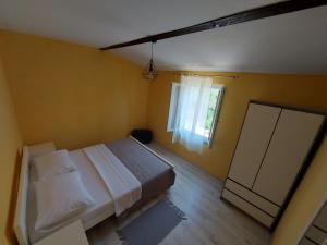 a bedroom with a large bed and a window at Kuća za odmor TONI in Zaglav