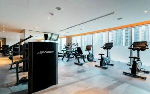 a gym with treadmills and exercise equipment in a building at Delightful One-Bedroom in DownTown Dubai in Dubai
