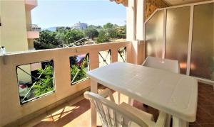 a balcony with a table and a laptop on it at HotelApart Filoxenia in Alexandroupoli