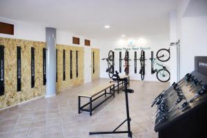 a room with bikes on the wall and a bench at Chatur Playa Real Resort in Adeje