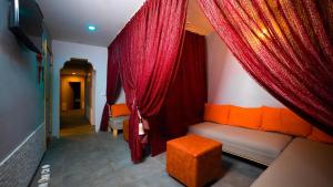 a living room with red curtains and a couch at Old Town Point Hotel & Spa Antalya in Antalya