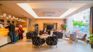 a lobby with a table and chairs and people in a room at Old Town Point Hotel & Spa Antalya in Antalya