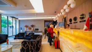 a restaurant with people waiting at a counter at Old Town Point Hotel & Spa Antalya in Antalya