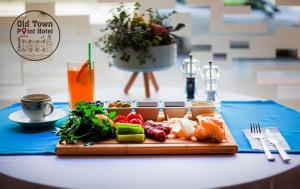 a tray of food on a table with a plate of food at Old Town Point Hotel & Spa Antalya in Antalya