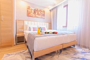 a bedroom with a bed with a toy on it at Old Town Point Hotel & Spa Antalya in Antalya