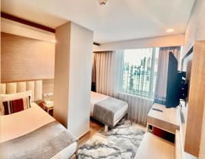 a hotel room with two beds and a window at Old Town Point Hotel & Spa Antalya in Antalya