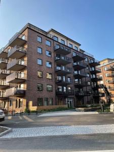 a large brick apartment building with a parking lot at Casa Silvborn in Gothenburg