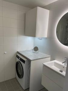 a bathroom with a washing machine and a sink at Casa Silvborn in Gothenburg