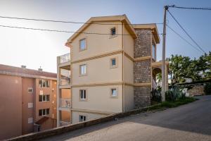 a building on the side of a street at Prijevor Apartments in Budva