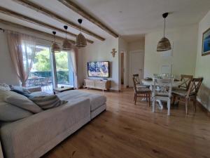 a living room with a couch and a table at Apartment Mia La Verna in Orebić