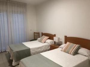 Postel nebo postele na pokoji v ubytování Apartamentos Raxo Mar