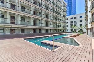 a building with a swimming pool in front of a building at The Icon Studio Apartment 1000 in Cape Town