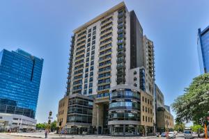 a tall building in a city with a street at The Icon Studio Apartment 1000 in Cape Town