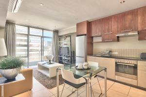 a kitchen with a table and a dining room at The Icon Studio Apartment 1000 in Cape Town