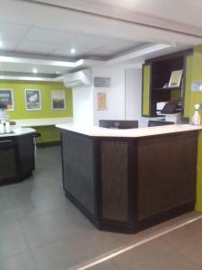 a kitchen with a counter in a room with green walls at SUN1 Kimberley in Kimberley