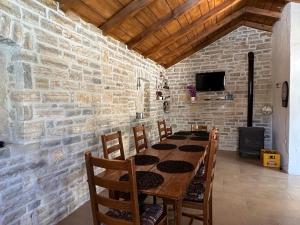 a dining room with a table and a brick wall at Leggiero in Benkovac
