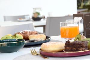 a table with a plate of food and a glass of orange juice at CORTE REALE Luxury B&B in San Salvo