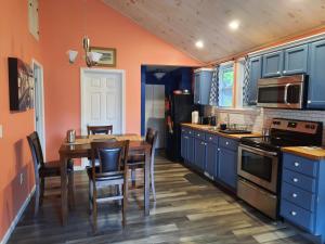 cocina con armarios azules y mesa de madera en Catskill, Your Place to Be, en Catskill