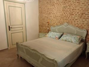 a bedroom with a bed and a brick wall at Appartamento Cico in Andezeno +81 photos